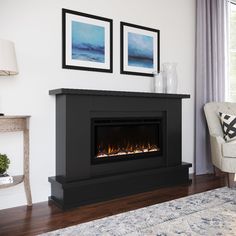 a living room with a fireplace and two pictures on the wall