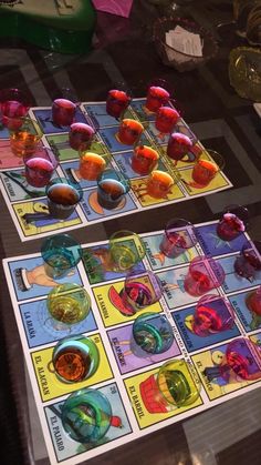 two game boards sitting on top of a table covered in plastic cups and saucers