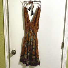 Never Worn Purchased At A Local Miami Boutique Mini V Neck Dress Elastic Waist Open Back Actually Listed As One Size As It Will Stretch To Fit Any Size Print Is Warm And Sexy Tassels At Halter Tie And Back Tie Brown V-neck Summer Sundress, Brown V-neck Dress For Beach Season, Hippie Sleeveless Brown Dress, Brown Summer Sundress For The Beach, Brown Summer Sundress For Vacation, Summer Brown Sundress For The Beach, Hippie Brown V-neck Dress, Brown Sleeveless Sundress For Beach, Brown Summer Mini Dress For Beach