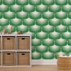 a green and white wallpaper with palm leaves in the middle, next to baskets