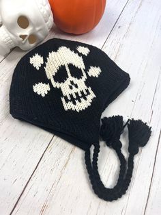 Introducing our Gothic Fashion Beanie, a must-have accessory for any edgy and alternative wardrobe.  This Black  Beanie features a classic black color and is adorned with gothic skulls, making it the perfect accessory for fans of the goth subculture.  Hand knitted with durable Wool and fully with soft fleece. Unisex design, handmade  Perfect beanie for this Winter. Made with 100%  New Zealand wool, lined with soft fleece.  Unique gift for your loved ones who are into gothic style.  Warm cap to w Adjustable Punk Beanie Hat, Punk Style Adjustable Beanie Hat, Punk Winter Hat For Festivals, Adjustable Punk Hat For Winter, Adjustable Punk Winter Hat, Black Novelty Beanie One Size Fits Most, Punk Style Winter Hats For Festival, Adjustable Punk Style Winter Hat, Black Novelty Beanie