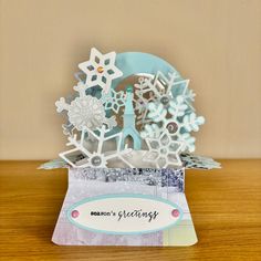 a card with snowflakes on it sitting on a table