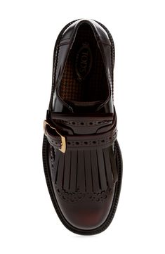 A logo-engraved buckle adds an understated heritage touch to a glossy patent-leather loafer boasting a classic wingtip and a fringed kiltie vamp. Adjustable-buckle monk strap Leather upper and lining/synthetic sole Made in Italy Designer Shoes