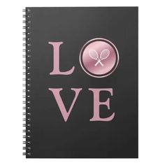 a notebook with the words love and a tennis racket in pink on a black background