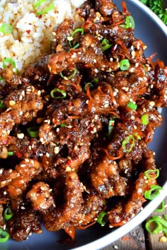 a white plate topped with meat and rice