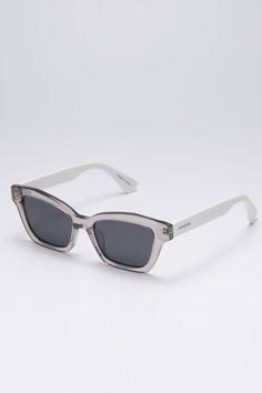 Frame: Clear gray and white acetate Lenses: Gray Lenses: 53 mm, Bridge: 18 mm, Temples: 145 mm Accentuate the opaque acetate rendering of these sunglasses with a cat-eye inspired silhouette, then accented with glossy white arms. The grey tinted lenses offer good UV protection. Plastic Sunglasses, Grey Sunglasses, Grey Lenses, Sunglass Frames, Glossy White, Uv Protection, Cat Eye, Cat Eye Sunglasses, Travel Style