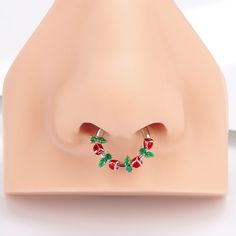 a pair of strawberry shaped earrings sitting on top of a white surface