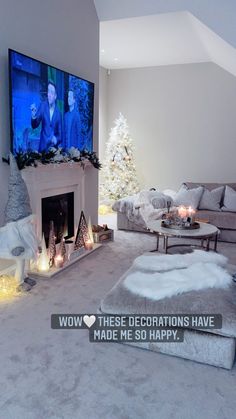 a living room filled with furniture and a flat screen tv mounted on the wall above a fire place