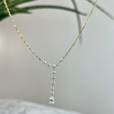 This luxurious 14K gold necklace is crafted with 12 round brilliant cut diamonds and one pear shape cut diamond totaling 91/100 carats. The diamonds feature a color grade of G-H and a clarity of VS2-SI1, perfect for making a statement. The 16-18 inch cable chain with lobster clasp provides adjustable length. This necklace can be customized or recreated to fit your needs. Please give us a call at 314-548-5100 to have your custom order placed. Diamond Lariat Necklace, Diamond Drop Necklace, Floating Necklace, Diamond Bar, 14k Gold Necklace, Unique Diamonds, Diamond Drops, Lariat Necklace, Drop Necklace