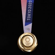 a gold medal with the olympic logo on it