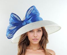 White Royal Blue Elegant Kentucky Derby Hats Ascot Church Race Day Tea Garden Party Wide Brim Wedding Formal Occasion Woman Bow White & Royal Blue Saskia Large Formal Ascot Hat for Kentucky Derby Church Weddings Classic Audrey Hepburn style Dome Down Turned wide brimmed sinamay hat trimmed with abacca silk trim The brim on the Saskia formal hat measures 41 cm side to side with a crown height of 11cm The Saskia hat has an inside circumference is 58cm.  Looking for the perfect accessory for your n Fitted Royal Blue Hat For Summer, Blue Fascinator For Summer Garden Party, Royal Blue Fascinator For Summer Weddings, Fitted Blue Fascinator For Garden Party, Blue Fitted Fascinator For Garden Party, Fitted Royal Blue Wedding Hat, Royal Blue Summer Wedding Fascinator, Royal Blue Wedding Fascinator, Fitted Blue Hat For Garden Party