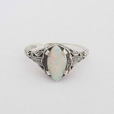 Vintage Sterling Silver White Opal Filigree Ring...Marked 925...Total of weights 1.7grams...Measure of Face 10MM...Size 8....It's in good condition. Heirloom Style Silver Opal Ring, Heirloom Silver Opal Ring, Heirloom Silver Opal Promise Ring, Antique Sterling Silver Opal Ring For Anniversary, Antique Silver Opal Ring For Anniversary, Vintage Sterling Silver Opal Wedding Ring, Vintage Sterling Silver Opal Ring For Wedding, Collectible Sterling Silver Ring With Intricate Design, Sterling Silver Filigree Rings Collectible