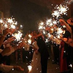 a group of people holding sparklers in their hands