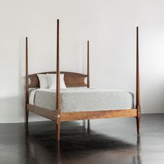 a bed with four posts in a room