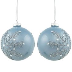 two blue christmas ornaments hanging from strings