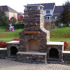 a brick oven sitting in the middle of a yard