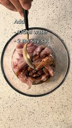 a person is cooking meat in a glass bowl on the counter with ingredients labeled below