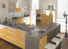 a modern kitchen with yellow cabinets and stainless steel counter tops, along with white stools