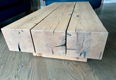 a table made out of wooden planks sitting on top of a hard wood floor