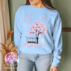 My latest creation is a heartfelt tribute to my all-time favorite song, "Spring Day." This sweatshirt is a visual ode to the emotions and beauty that this song encapsulates. I've poured my heart into crafting a design that captures the essence of "Spring Day." It's a piece of art that reflects the deep lyrics and the emotions it stirs. Comfort is always a priority. That's why I've chosen a top-quality sweatshirt that feels incredibly soft against your skin.  * 50% cotton, 50% polyester * Pre-shr Casual Tops With Custom Artwork For Gift, Casual Tops With Custom Artwork As Gift, Casual Spring Fan Merchandise T-shirt, Multicolor Kawaii T-shirt For Spring, Spring Kpop T-shirt With Graphic Print, Spring Kawaii Multicolor T-shirt, Deep Lyrics, Spring Birth Flower Crew Neck T-shirt, Bts Spring Day