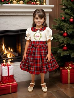 ✿ABOUT THIS DRESS ✓Our handmade tartan dress is the perfect combination of stylish and comfortable.  ✓The fluffy red tartan skirt adds a playful touch, while the white top with a holly flower wreath with personalized name embroidery inside embroidery maintains elegance.  ✓The 100% cotton lining ensures your little one will be comfortable all day. ✿FABRIC INFORMATION ✓Natural cotton lining is under the skirt, tulle, crepe fabric, and red tartan on the top. ✓ The color of your item may vary slight Plaid Christmas Holiday Dress, Plaid Dress For Christmas Holiday, Red Tartan Skirt, Red Baby Dress, Holly Flower, Christmas Tartan, Xmas Outfit, Skirt Tulle, Heirloom Dresses