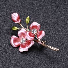 Add a little vintage-inspired charm to your ensemble with this stunning brooch featuring a floral motif. 1.14" W x 2.08" L 18k gold-plated copper / enamel / cubic zirconia Elegant Spring Brooch Jewelry, Elegant Spring Gift Brooches, Elegant Spring Brooch, Flower Shaped Enamel Pin For Gift, Elegant Pink Enamel Brooch Pin, Elegant Pink Enamel Pin, Elegant Gold Brooches For Spring, Gold Brooches For Spring Gift, Elegant Pink Enamel Pin For Gift