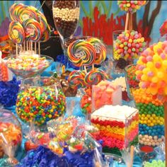 a table filled with lots of candy and lollipops