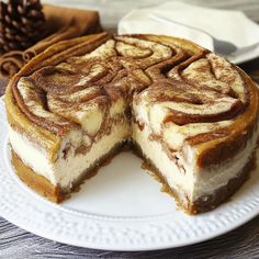 a cheesecake on a plate with one slice cut out