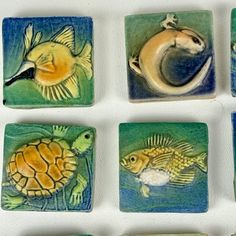 nine ceramic tiles depicting different types of sea animals