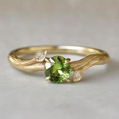 *Ethically Sourced Sapphire, crafted with care and conscience for the conscious wearer. Each piece is handcrafted with 10k/14k/18k gold / platinum / silver in your choice. *Gem: Green Peridot 5mm, Moissanite 1.5mm **PERIDOT The stone of compassion. Peridot is believed to bring good health, restful sleep and peace to relationships by balancing emotions and mind. This friendly bright green stone also has the uncanny ability to inspire eloquence and creativity, it also brings delight and good cheer Luxury Elegant Green Cluster Ring, Luxury Green Engraved Ring, Luxury Green Peridot Diamond Ring, Luxury Peridot Birthstone Ring With Accent Stones, Raw Peridot Ring, Luxury Peridot Three-stone Rings, Green Stone Wedding Ring, Gold Ring Green Stone, Proposal Ring Gold