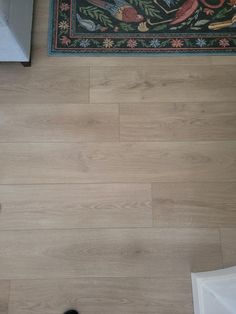 an overhead view of a bathroom with wood flooring