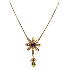 This stunning floral pendant necklace is modern but also classic vintage. The necklace is from the early 1900's and replicates a beautiful flower with petals adorned in tiny seed pearls. The center is a round faceted amethyst and the bottom petal has a drop of seed pearls accenting an oval faceted peridot. The necklace is 16 inches long so it rests beautifully on your collarbone. Gorgeous! Luxury Victorian Flower Pendant Necklace, Luxury Antique Flower Pendant Necklace, Heirloom Formal Necklace With Flower Pendant, Heirloom Style Formal Necklace With Flower Pendant, Heirloom Flower Pendant Necklace For Formal Occasions, Ornate Flower Pendant Necklace For Formal Occasions, Vintage Necklace With Flower Pendant, Antique Hallmarked Flower Pendant Necklace, Victorian Flower Pendant Necklaces For Wedding