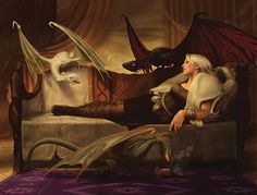 a woman sitting on top of a bed next to a dragon