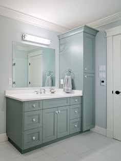 a bathroom with two sinks and a large mirror on the wall next to a door