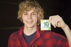 a young man is holding up a 10 on top sticker