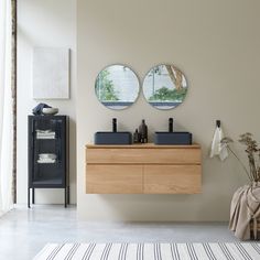 a bathroom with two circular mirrors on the wall