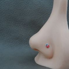 a white plastic head with a red and blue pin on it