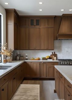 a kitchen filled with lots of wooden cabinets and counter top space next to a window