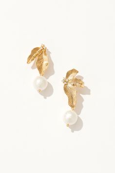 Whimsical leaf motifs paired with timeless pearl elegance. Elegant Leaf-shaped Earrings, Elegant Leaf-shaped Jewelry For Formal Occasions, Elegant Leaf-shaped Formal Jewelry, Elegant Leaf-shaped Jewelry With Matching Earrings, Elegant Leaf-shaped Earrings For Party, Elegant Leaf-shaped Earrings For Formal Occasions, Elegant Leaf-shaped Party Earrings, Elegant Leaf-shaped Formal Earrings, Elegant White Leaf-shaped Earrings