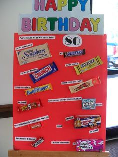 a candy bar birthday sign is displayed in front of a window