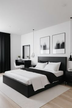 a white and black bedroom with pictures on the wall