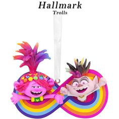 an ornament with two cartoon characters hanging from it's sides, one wearing a rainbow hat and the other as a pineapple