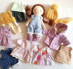 doll clothes laid out on a white surface