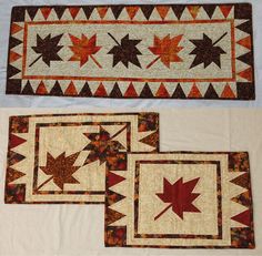 three quilted placemats with maple leaves on them