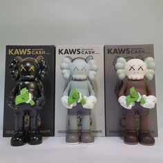 three kaws cash figures sitting next to each other