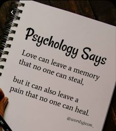 a hand holding a pen next to a spiral notebook with the words, psychology says i love can leave a memory that no one can steal