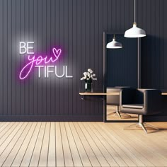 a room with a desk, chair and neon sign that says be your tiful