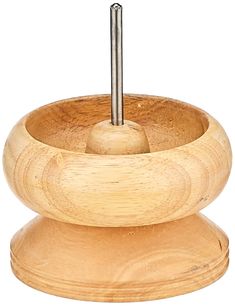 a wooden bowl with a metal handle on the top and an object in the middle