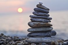 a stack of rocks sitting on top of a beach