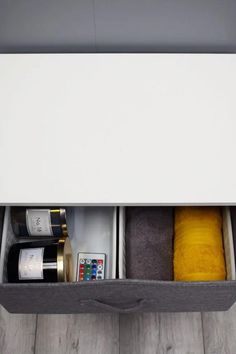 an open drawer with wine bottles and other items in it